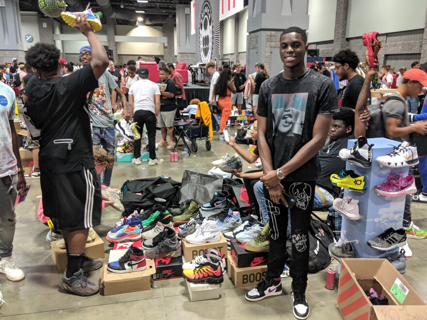 Lateef Amdali, 18, stands with his collection of shoes. Amdali starting buying and selling shoes by the time he was 13 years old. He says his most memorable flip to date netted him over $1,000 in profit off of just one shoe.