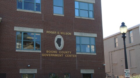 A close up of the exterior sign on the Boone County Government Center that includes an outline of the county map.