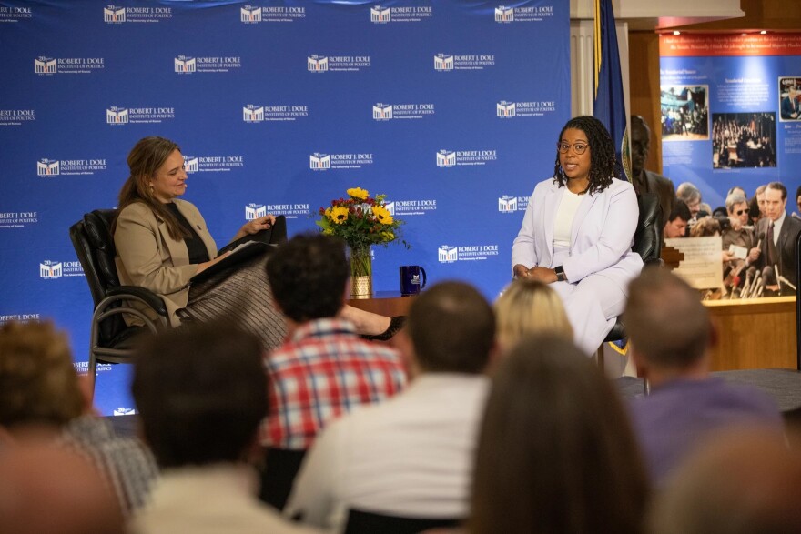 Audrey Coleman, Juana Summers in front of blue Dole Institute backdrop
