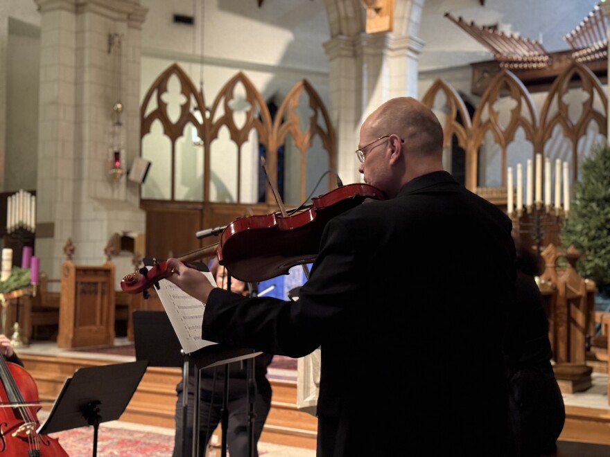 Carl Kerner practices on the violin right before the Blue Christmas Service at the Cathedral Church of Saint Luke.