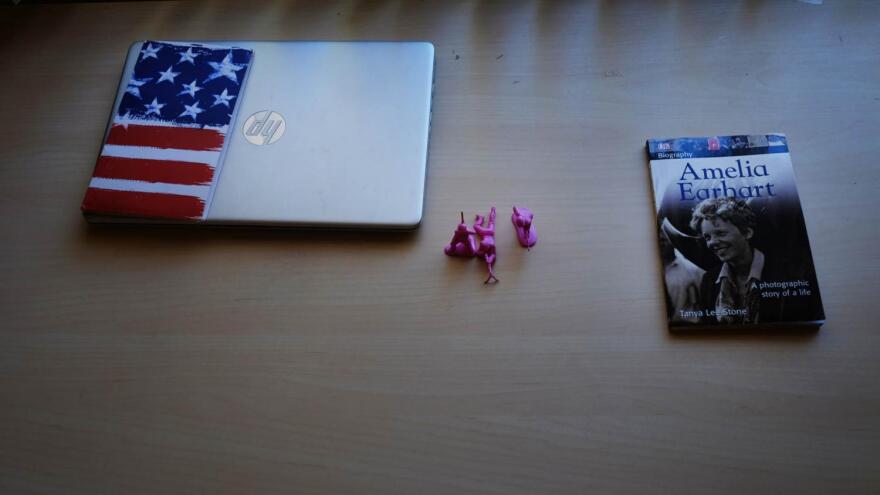 A laptop, book and pink soldier figurines sit atop a desk inside the Tempe apartment where some former platoon members live. Richardson's family gave A an Amelia Earhart book after hearing about her plan to become a pilot herself one day.