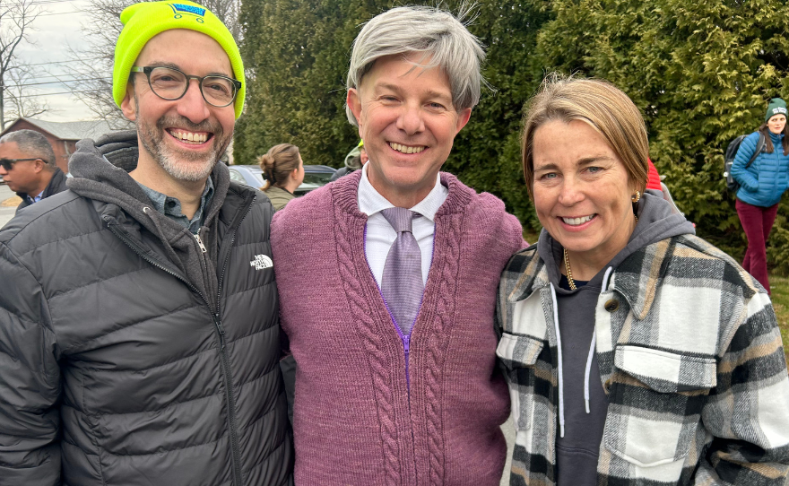 Monte Belmonte, dressed as Mister Rogers, stands with Governor Maura Healey and NEPM President Matt Abramovitz at the 16th annual March for the Food Bank.