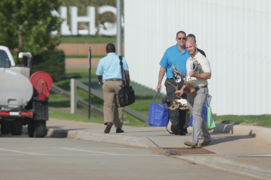 Former Chesapeake Energy employees leave the building with their belongings after the Sept. 29, 2015 buyouts.