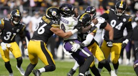 Pittsburgh Steelers linebacker Alex Highsmith (56) and linebacker Cole Holcomb (55) tackle Baltimore Ravens quarterback Lamar Jackson (8) in the second half of an NFL football game in Pittsburgh, Sunday, Oct. 8, 2023. (AP Photo/Gene J. Puskar)