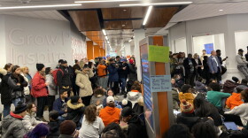 More than 100 Syracuse University students staged a sit-in on campus Wednesday, protesting the university's response to racist messages found in a residence hall