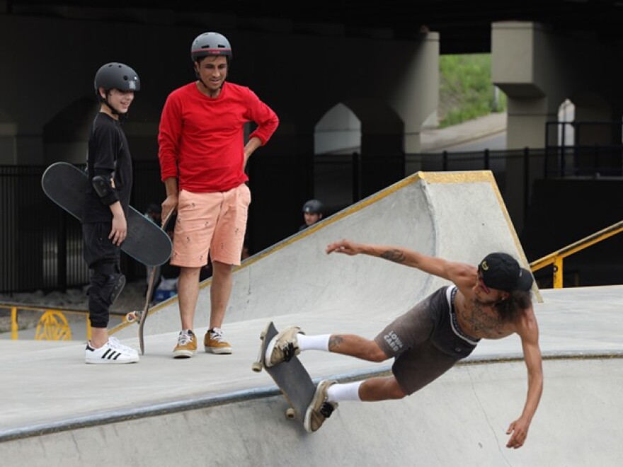 Skateistan instructor Farzad Sharafi stands with Rochester International Academy student Mohammad watching some of the local skaters shred the bowl at the ROC City Skatepark.