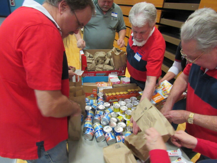 Volunteers from the Elks in Seattle and Shoreline pack take away bags for needy vets at a stand down event.
