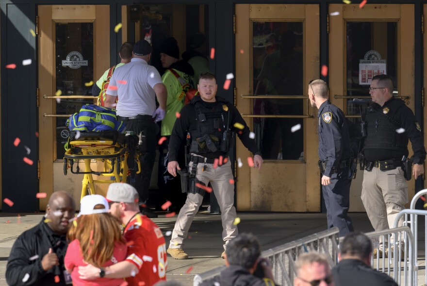 Emergency personnel, left, take a stretcher into Union Station following a shooting at the Kansas City Chiefs NFL football Super Bowl celebration.