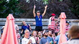 Fans celebrate a goal by the United States while watching Wednesday’s World Cup match between the USA and Bosnia and Herzegovina on an outdoor screen at The Little Fleet in Traverse City.