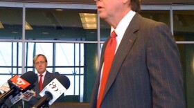 Mayor Bartlett announces budget cuts as chief-of-staff Terry Simmonson watches.