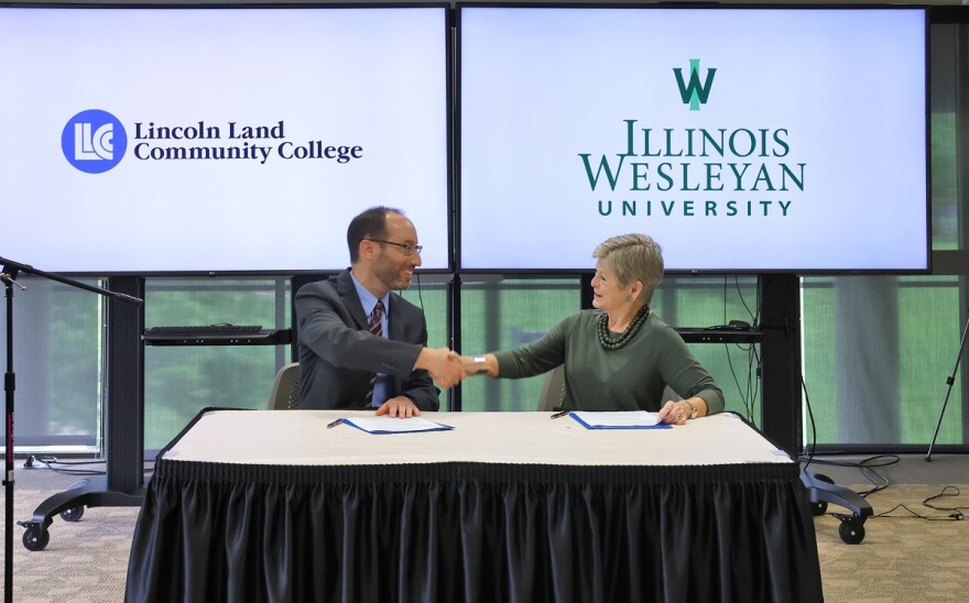 Jason Dockter, interim vice president of academics at LLCC and Georgia Nugent, president of Illinois Wesleyan University, signed a guaranteed admission agreement between the two institutions.