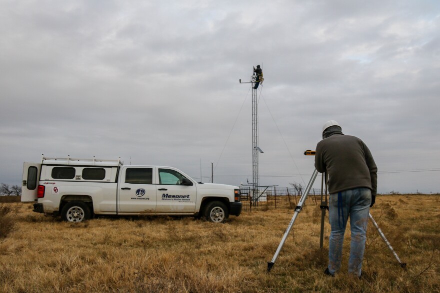 Meteorological Electronics Technicians Christopher Bieschke and Kirk Wilson replace a wind sensor atop a 30-foot tower at an Oklahoma Mesonet station near Shawnee, Okla.