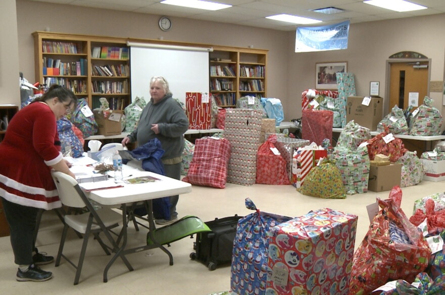 Volunteers prepare gifts for donation at Trinity Lutheran Church