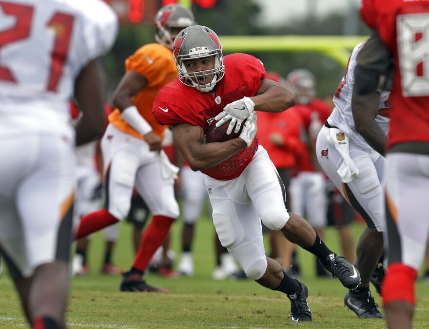 Tampa Bay Buccaneers running back Doug Martin runs through a hole in the line  