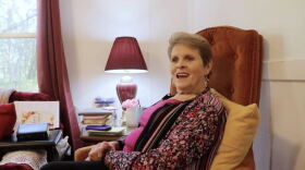 Woman sitting on a chair and smiling into the camera
