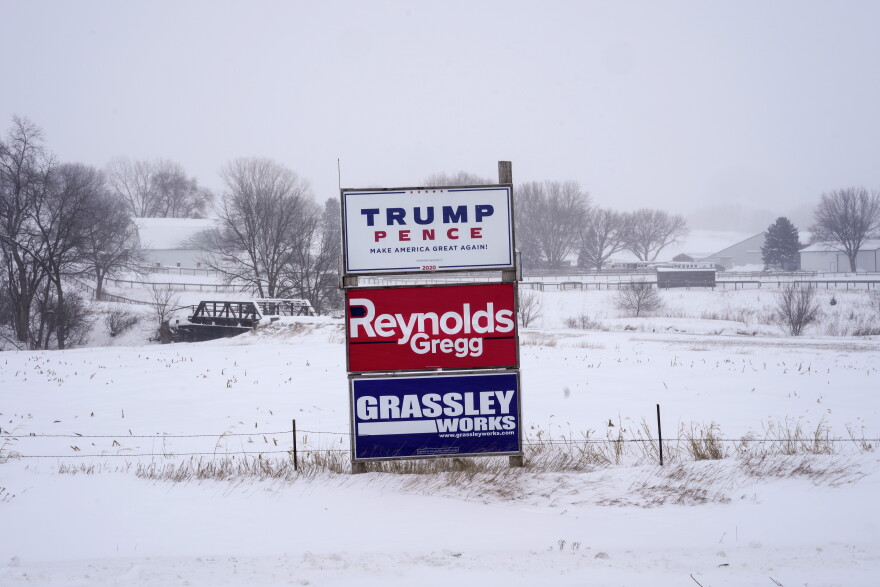 Campaign signs are seen during a winter storm in Sioux City, Iowa on Friday.