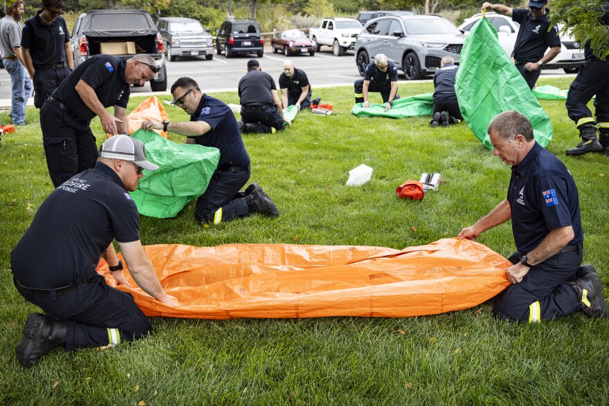 Aussie and Kiwi firefighters practice getting into fire shelters at the National Interagency Fire Center in Boise.