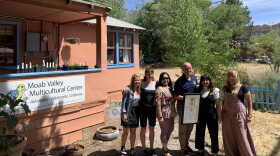 Members of the Moab Valley Multicultural Center with Governor Cox, holding the Spirit of Service award