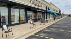 chairs set up on sidewalk for curbside delivery