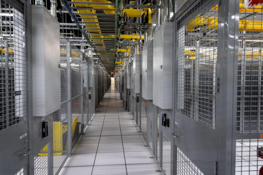 A walkway between cages of servers at Equinix’s data center in Billerica, Mass.  (Robin Lubbock/WBUR)