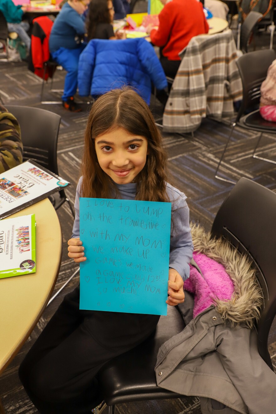 Talaiya with her poem composed during the 13th annual 3rd Grade Poetry Slam