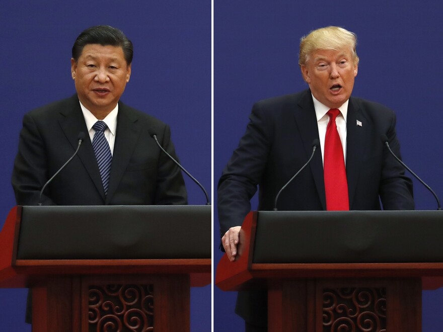 U.S. President Donald Trump, right, and Chinese President Xi Jinping speak during a business event at the Great Hall of the People in Beijing November 2017.