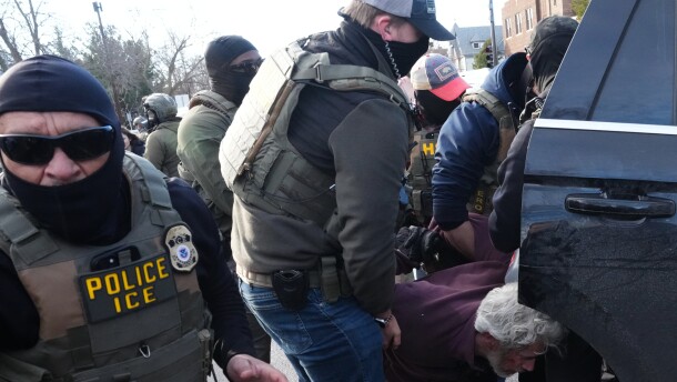 A protester is detained by Federal agents near the scene where Renee Good was fatally shot by an ICE officer last week, Tuesday, Jan. 13, 2026, in Minneapolis.