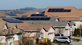 Solar panels sit on rooftops at a housing development in Folsom on Feb. 12, 2020.