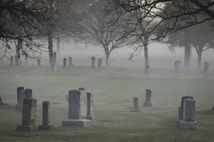 Fog settles over gravestones in a Kansas City cemetery.