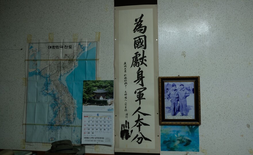 On the wall in Park's office hangs a piece of Chinese calligraphy, which says: "It's a soldier's duty to sacrifice himself for his country." It was written by a Korean revolutionary who fought Japanese colonial rule. To the right is a picture of Park taken during the Korean War.