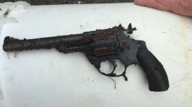 a dirty revolver dug up from the ground