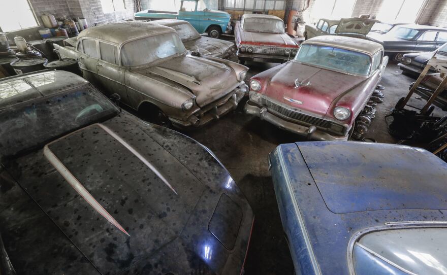 A file photo from August shows some of the cars that had been stored in the old showroom of the former Lambrecht Chevrolet dealership. At this weekend's auction, several of the previously unsold vehicles will come with their original paperwork and a new Nebraska title and bill of sale.