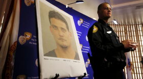 Tallahassee Police Department Public information officer David Northway reveals an image of Sigfredo Garcia, 34, during a press conference in Tallahassee, Fla., Thursday, May 26, 2016. Garcia is wanted for the murder of Florida State University law professor Dan Markel. Markel was killed in his Tallahassee home in July 2014. (Joe Rondone/Tallahassee Democrat via AP)