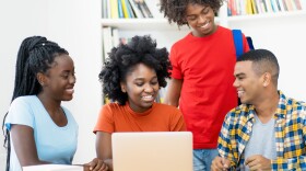 Group of african american and latin students editing video clip at computer at classroom of university