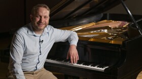 Louie Hehman the Assistant Professor of Music and Bellarmine alum, poses for a portrait with a piano in the Amy Cralle Theatre at Bellarmine University in Louisville, Kentucky on August 16, 2024. BRENDAN J. SULLIVAN/ BELLARMINE UNIVERSITY