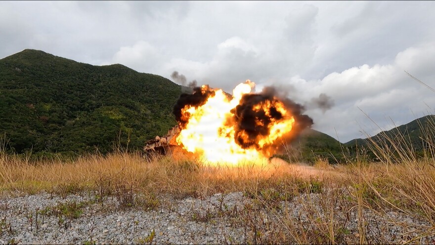 A drone detonates at a simulated target during the Marine Corps Attack Drone Competition in Okinawa, Japan, Dec. 11, 2025. The U.S. is trying to keep up with other nations, which are more actively deploying small, relatively inexpensive attack drones for warfare. 