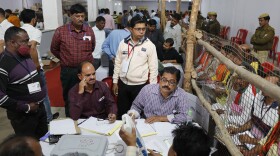 Election officials count votes after Uttar Pradesh state elections in Lucknow, India on Thursday.