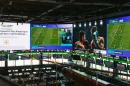 A massive 2,000-square-foot television wraps around the DraftKings Sports Bar at Wrigley Field.