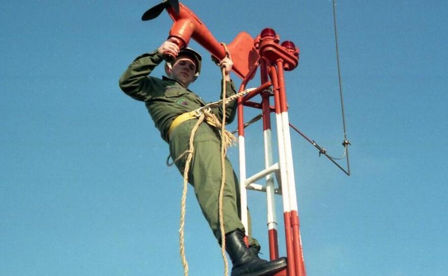 Lynn Eldredge started his working life in the Air Force in 1985. Here, he's installing a wind speed and direction transmitter.