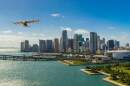 A sixth-generation Wisk is depicted self-flying taxi over the Miami skyline 