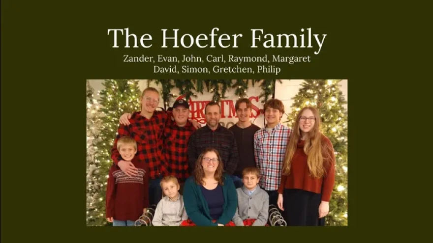 a holiday picture of a family with two parents and eight children