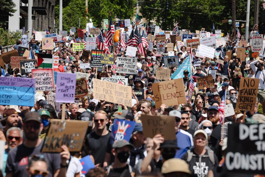 Thousands march down Denny Way toward the Seattle Center.