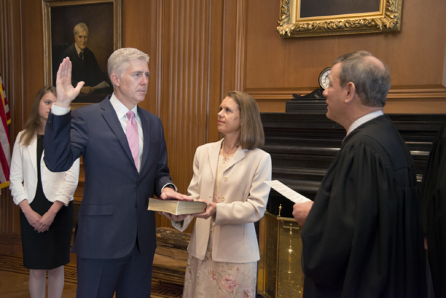 Supreme Court Justice Neil M. Gorsuch takes the judicial oath of office in 2017. Gorsuch may be the deciding vote in a case over whether the Civil Rights Act of 1964 prohibits discrimination based on sexual orientation and gender identity.