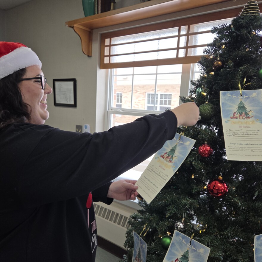 Havenwood Activity Director adjusts tags on the Angel Tree during a holiday party in Bemidji on Dec. 11, 2025.
