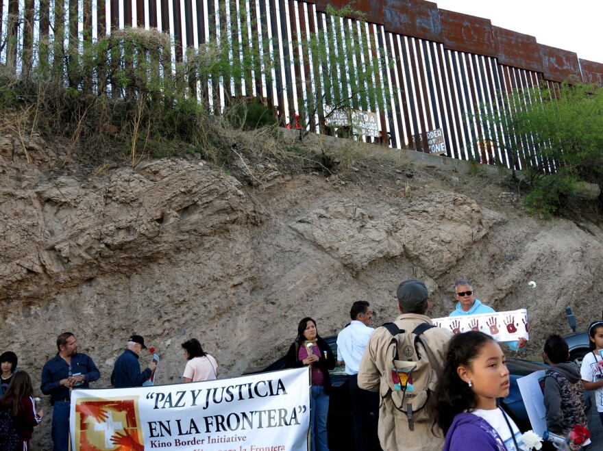 About 100 people gathered at the U.S.-Mexico border for a vigil in memory of Mexican teen Jose Antonio Elena Rodriguez, who was shot by a Border Patrol agent.
