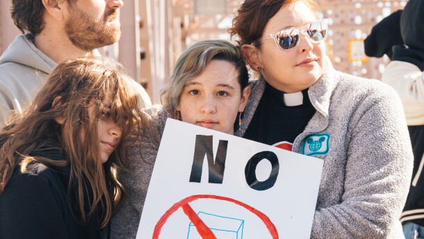 The Rev. Katie Nix, lead pastor at Grace United Methodist Church in University City, right, embraces her daughter Elizabeth Nix, center, and Allison Brodie, left, while rallying against ICE alongside hundreds of faith leaders and community members on Feb. 16 in downtown St. Louis.