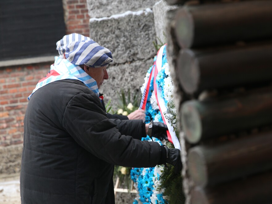 A former prisoner pays tribute during the 74th anniversary of the liberation of Auschwitz.