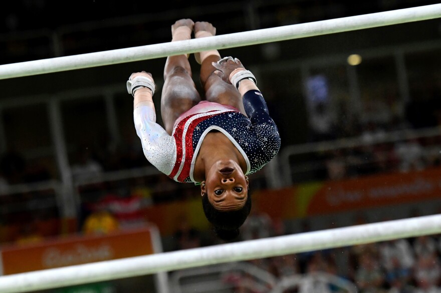 Gabby Douglas of the United States competes in the uneven bars during the women's team final.