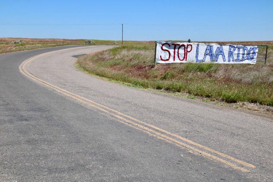 A hand-drawn banner says "Stop Lava Ridge" on the side of a road in Jerome County.