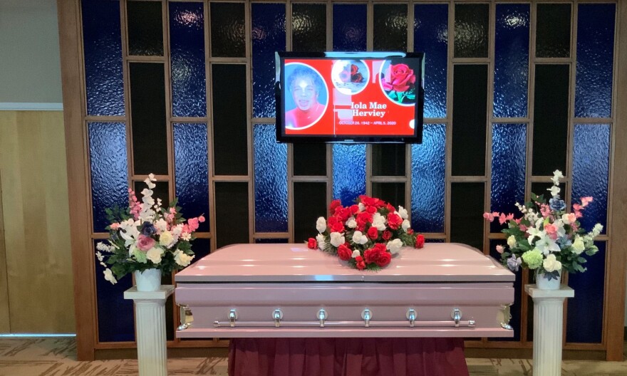 Iola Mae Herviey's casket rests beneath a monitor prior to her funeral which was conducted via Zoom.